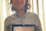 Marco Farina con un premio ricevuto per il libro "Ricominciare"