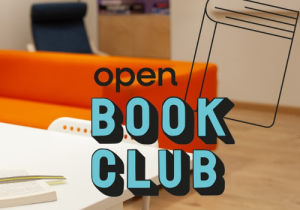 Libro stilizzato, la scritta "Open Book Club" e sullo sfondo un divano arancione