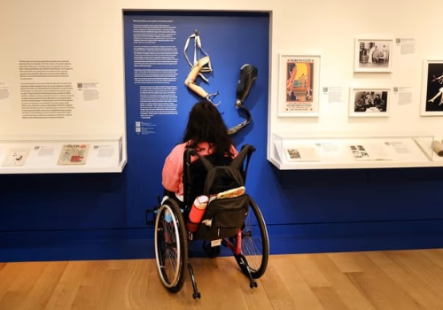 Donna in carrozzina in visita ad un museo