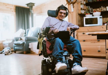 Giovane con disabilità in carrozzina in casa