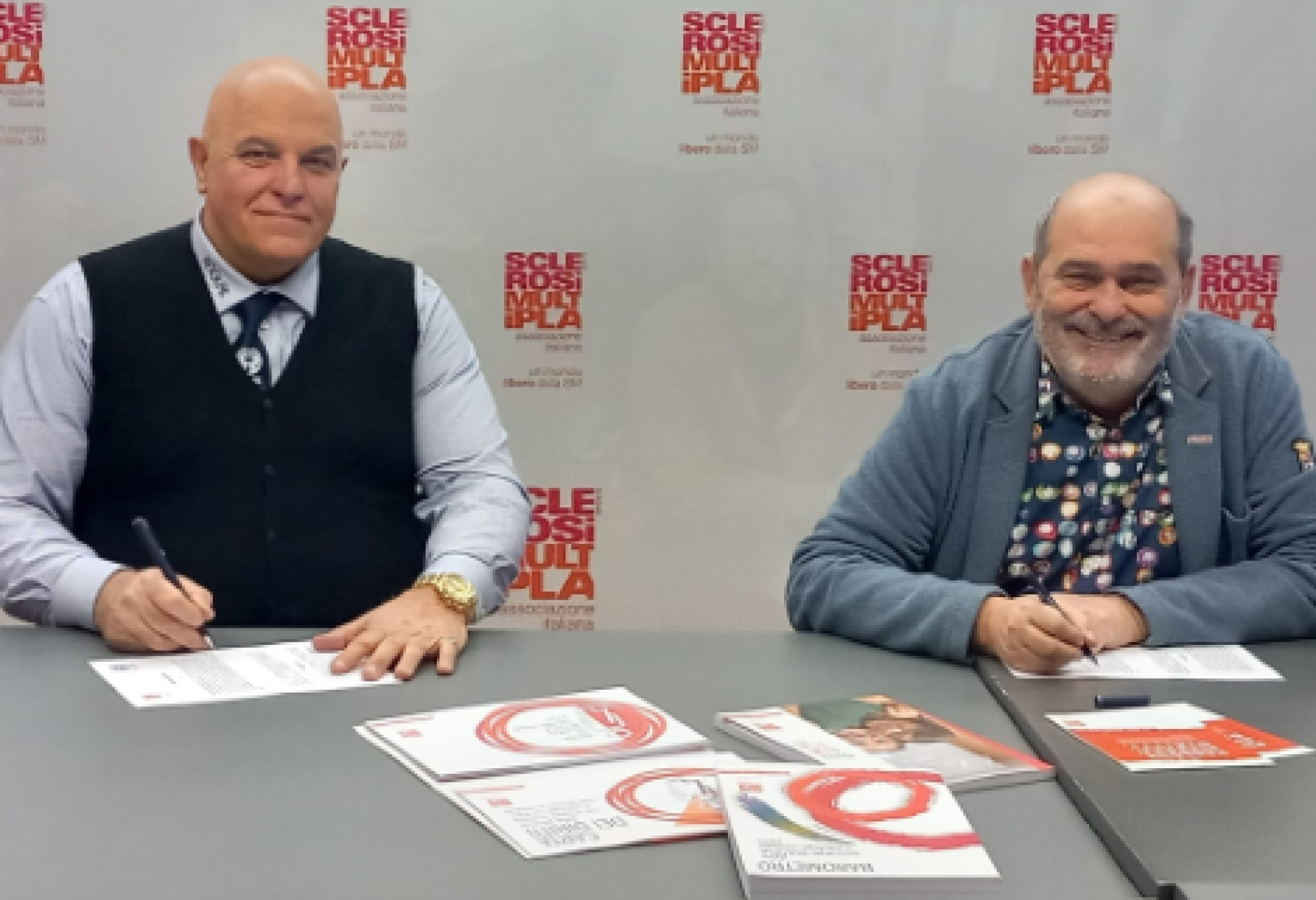 Il presidente dell'AISM Francesco Vacca (a destra) e il presidente dell'ANGLAT Claudio Puppo sottoscrivono il Protocollo d'Intesa tra le due Associazioni