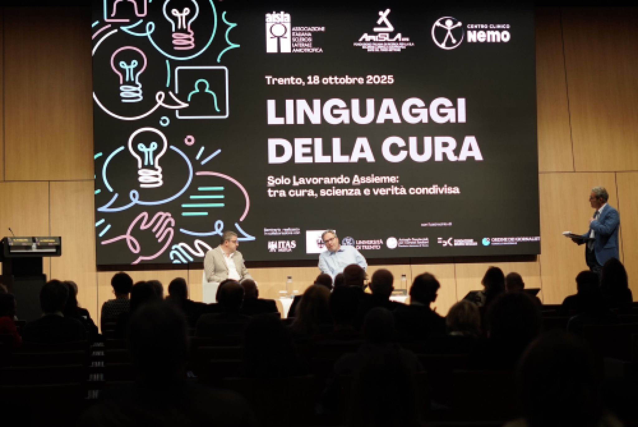 Il presidente della Provincia Autonoma di Trento Fugatti (a sinistra) e il segretario nazionale dei Centri Clinici NeMo Fontana, sul palco dell'incontro di Trento